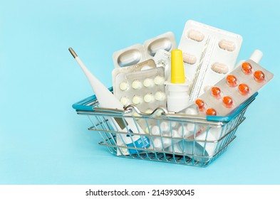 Medical Supplies To The Shopping Cart Close-up On A Blue Background