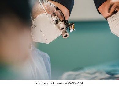 Medical surgeon team operating patient in surgical room at private clinic - Focus on center male doctor face - Shutterstock ID 2006355674