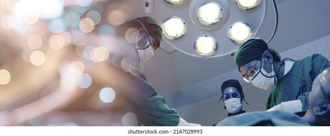 Medical Surgical Doctor Team Performing Surgery Patient, Group Surgeon At Work On Operating Room With Electrocautery Equipment For Cardiovascular Emergency Surgery Center In Hospital