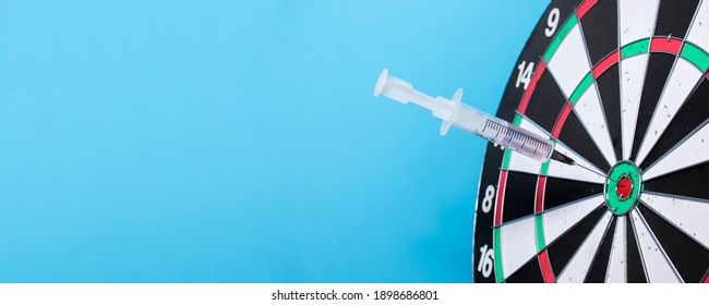 Medical syringe in general for dart throwing. The concept of success in the treatment of diseases, the correct selection of drugs, the success of vaccines and the victory over Covid-19.