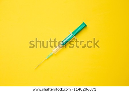 Medical syringe on colorful background.