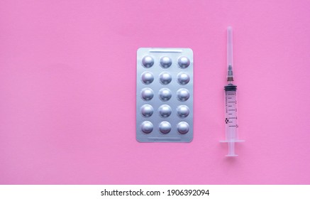 Medical Syringe With Pills On Pink Background, Health And Vaccination Concept. Flat Lay Items For Doctor Using Treat Patient Covid-19. Flat Lay, Mockup, Overhead, Top View And Copy Space.