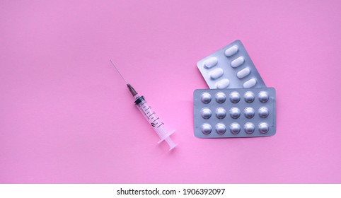 Medical Syringe With Pills On Pink Background, Health And Vaccination Concept. Flat Lay Items For Doctor Using Treat Patient Covid-19. Flat Lay, Mockup, Overhead, Top View And Copy Space.