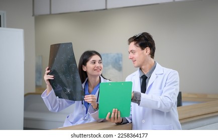 Medical teacher and interns analyzing the x-ray results of the patient's brain. before major surgery in the operating room - Powered by Shutterstock