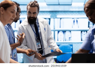 Medical team discusses x ray results and patient care strategy in a treatment center, expertise in radiology and disease prevention. Collaborative work ensures accurate diagnosis and medicine. - Powered by Shutterstock