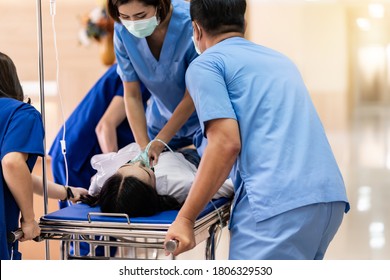 Medical team do CPR Cardiopulmonary resuscitation to seriously injured patient with oxygen mask while push gurney stretcher bed to Operating Room. Emergency health care and medical hospital concept. - Shutterstock ID 1806329530
