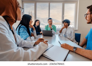 A medical team of doctors discussing at a meeting in the conference room. - Powered by Shutterstock