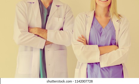 A medical team of doctors, man and woman, isolated on white background. Doctors. Two happy smiling young medical people  at professional hospital. Doctors. Teamwork. - Shutterstock ID 1142007728