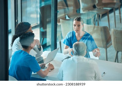 Medical team, doctors and meeting with a laptop for a discussion, planning or research at table. Men and women healthcare group talking about communication strategy, virus or surgery in a hospital - Powered by Shutterstock