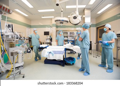 Medical team having a discussion in operation room - Powered by Shutterstock