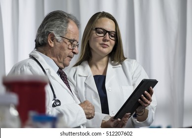 Medical Team Looking At An Ipad/tablet Computer Together