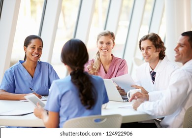 Medical Team Meeting Around Table In Modern Hospital - Powered by Shutterstock