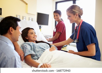 Medical Team Meeting With Couple In Hospital Room