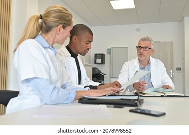 Medical Team Meeting In Hospital Room