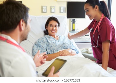 Medical Team Meeting With Woman In Hospital Room