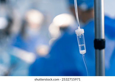 Medical team in operating room. A medical team works diligently in an operating room while an intravenous drip is seen, highlighting a critical healthcare moment. - Powered by Shutterstock