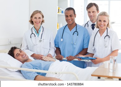 Medical Team And Patient Smiling And Looking At The Camera