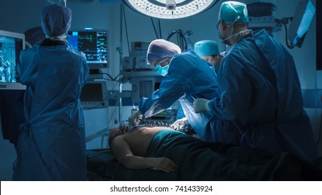 Medical Team Performing Defibrillation In Modern Operating Room.