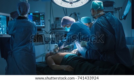 Medical Team Performing Defibrillation in Modern Operating Room.