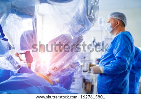 Medical team performing operation. Group of surgeon at work in operating theatre