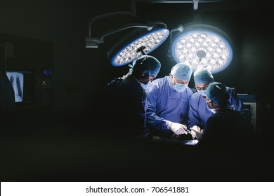 Medical team performing surgery. Group of surgeons in hospital operation theater. - Shutterstock ID 706541881