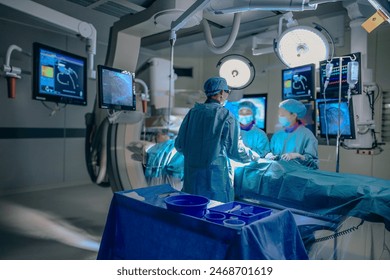 Medical Team Performing Surgical Operation in Modern Operating Room. Group of surgeons at operation in operating room at hospital. - Powered by Shutterstock