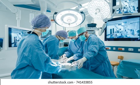 Medical Team Performing Surgical Operation in Bright Modern Operating Room - Shutterstock ID 741433855