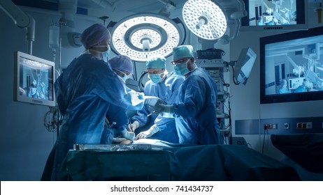 Medical Team Performing Surgical Operation in Modern Operating Room - Powered by Shutterstock
