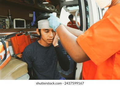 Medical team rescue workers Volunteer workers work team leading ambulance to care injured man in a car accident highway had head injury and received first aid until he was safe and was taken hospital. - Powered by Shutterstock