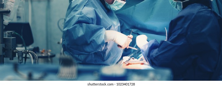 Medical team of surgeons in hospital doing minimal invasive surgical interventions. Surgery operating room with electrocautery equipment for cardiovascular emergency surgery center. - Shutterstock ID 1023401728