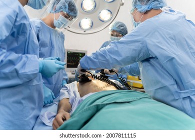 Medical team in Surgical gown help patient to making CPR Cardio Pulmonary Resuscitation in the operation room in hospital - Powered by Shutterstock