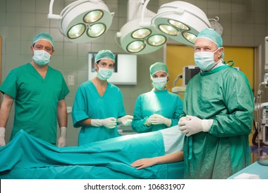 Medical Team Surrounding A Patient In A Surgical Room