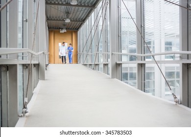 Medical Team Walking Down Hallway At The Hospital