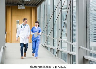 Medical Team Walking Down Hallway At The Hospital
