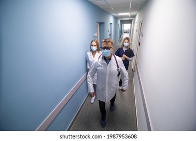 Medical Team Walking Hallway At The Hospital