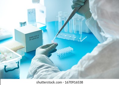 Medical Tech In Protective Suit, Mask And Glasses Works With Patient Swabs To Detect Specific Region Of 2019-nCoV Virus Causing Covid-19 Viral Pneumonia. SARS-COV-2 Pcr Diagnostics Kit Concept.