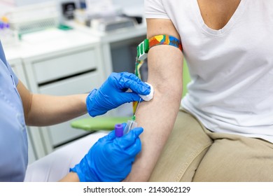 Medical Technologist Doing A Blood Draw Services For Patient. Lab Assistant With Sterile Rubber Gloves Taking Blood Sample From Patient.