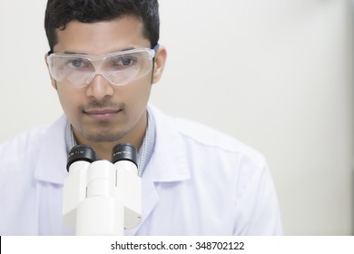 Medical technologist, Scientist student male looking in a microscope, science laboratory concept