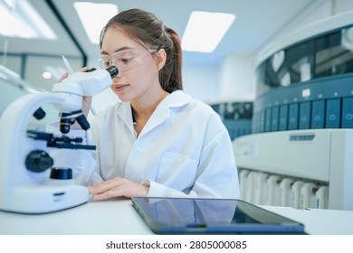 Medical technologist validating automated analyzer results against microscopic observations. Biomedical engineer configuring diagnostic instrument parameters using digital control interface.