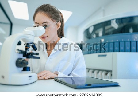 Medical technologist validating automated analyzer results against microscopic observations. Biomedical engineer configuring diagnostic instrument parameters using digital control interface.