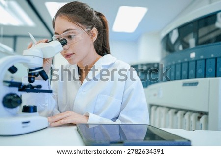 Medical technologist validating automated analyzer results against microscopic observations. Biomedical engineer configuring diagnostic instrument parameters using digital control interface.