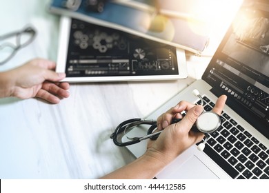 Medical technology concept. Doctor hand working with modern digital tablet and laptop computer and smart phone with graphics chart interface. On marble desk, Sun flare effect photo
