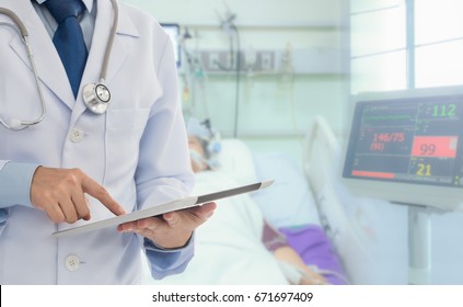 Medical Technology Concept. Doctor Using Digital Tablet In The Intensive Care Unit At The Icu Room.