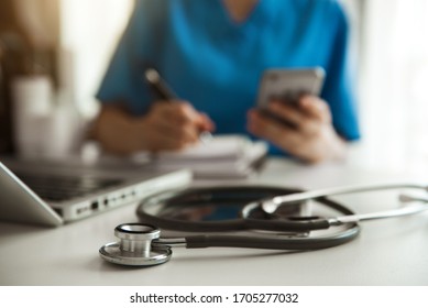 Medical technology concept. Doctor working with mobile phone and stethoscope in modern office

