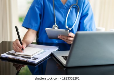 Medical technology concept. Doctor working with mobile phone and stethoscope and digital tablet laptop in modern office at hospital in morning light