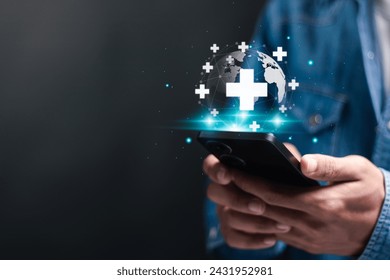 Medical technology concept.  Person use smartphone with globe with health care icon on virtual interface. Digital healthcare and medicine, internet network connection, Global health network. - Powered by Shutterstock