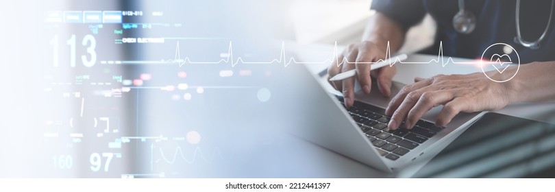 Medical technology, healthcare and medicine concept. Cardiologist doctor working on laptop computer with EKG heartbeat, vital signs monitoring on virtual screen, health technology background