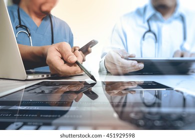 Medical Technology Network Team Meeting Concept. Doctor Hand Working With Smart Phone Modern Digital Tablet And Laptop Computer With Graphics  Chart Interface, Sun Flare Effect Photo