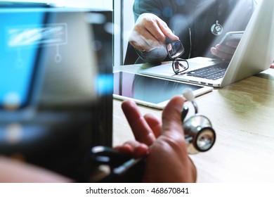Medical technology network team meeting concept. Doctor hand working smart phone modern digital tablet laptop computer chart interface, compact server foreground - Shutterstock ID 468670841