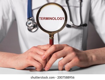 Medical Terminology Word Through Magnifier In Doctor Hands. Medicine Terms Concept.
